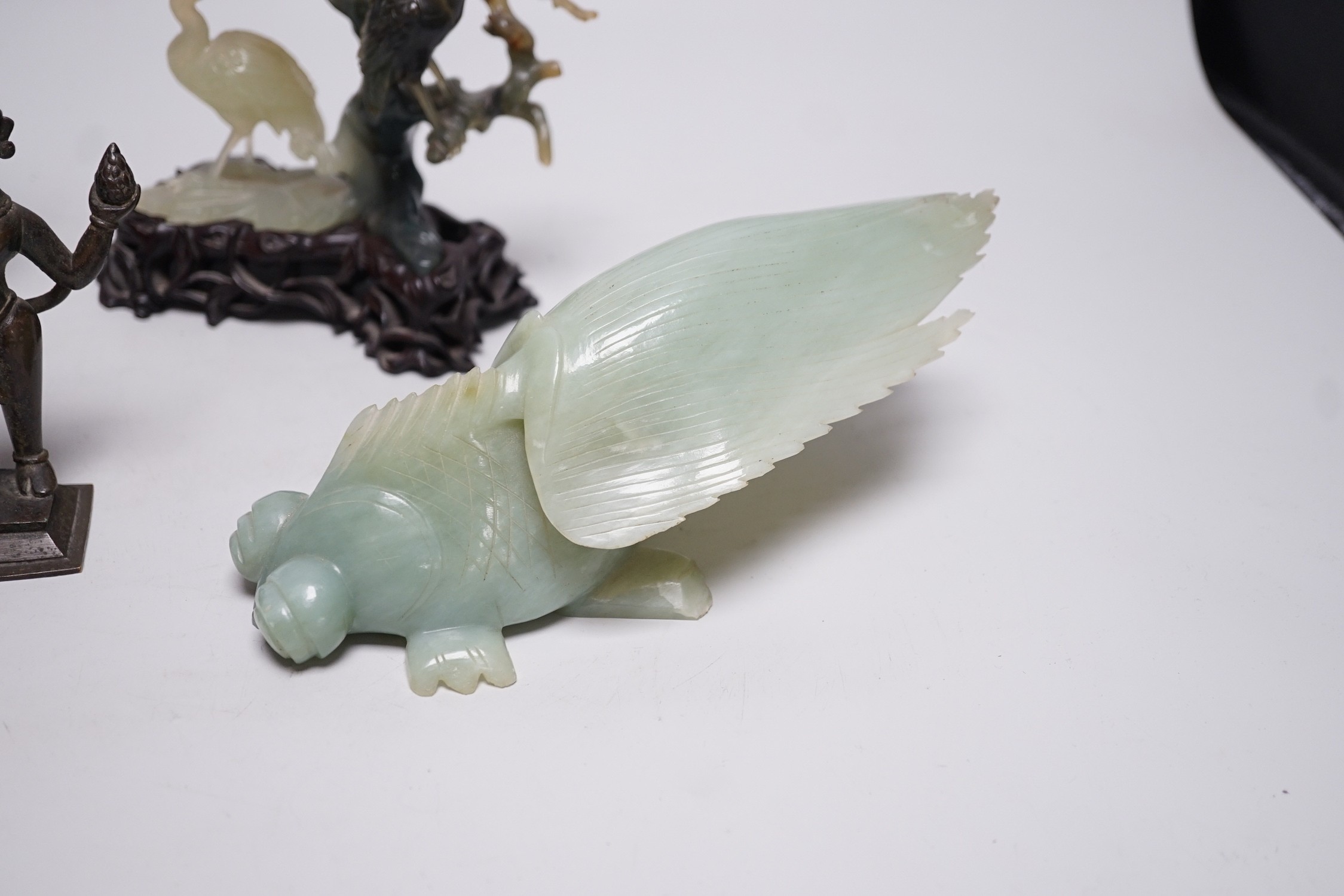 A Chinese bowenite jade bird group, together with a Jadeite figure of lady, 19.5cm high, a bowenite model of a goldfish, and an Indian brass figure